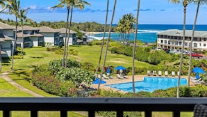 A resort with a pool, palm trees, and a view of the ocean. - KAUAI KONG QUARTERS OCEANVIEW 2 Bdrm 2 KINGS 1 TWIN. NextDoor2Hyatt Dining&Bars. (Koloa)