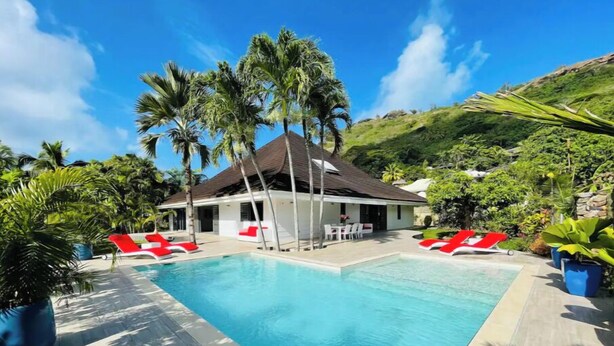 A pool area with lounge chairs, a house, and palm trees. - Unique luxuous 350sq m Villa with pool, fitness area, home cinema lounge .... (bora bora)