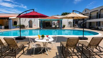 Outdoor pool, open 10:00 AM to 10:00 PM, pool umbrellas, sun loungers