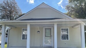 A single-story house with a front porch, a door with a glass panel, and a mailbox. - Home in Liberty (Liberty)