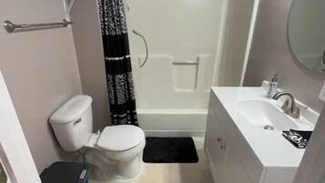 Bathtub, hair dryer, towels, soap