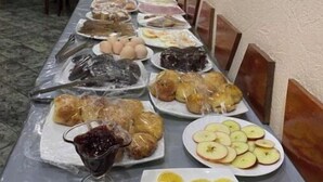 A buffet table with various dishes including fruits, bread, and a bowl of soup. - Ikan Hotel Double 2 (Yakkasaray)