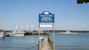 A dock with a sign reading "Welcome to the Greenport Visitors Dock" and "No Commercial Traffic". - Blue Bay Dream w/ Seasonal Outdoor Jacuzzi, Cabana + Office (Greenport,)