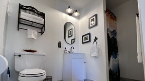 Ein modernes Badezimmer mit Toilette, Waschbecken und Dusche.