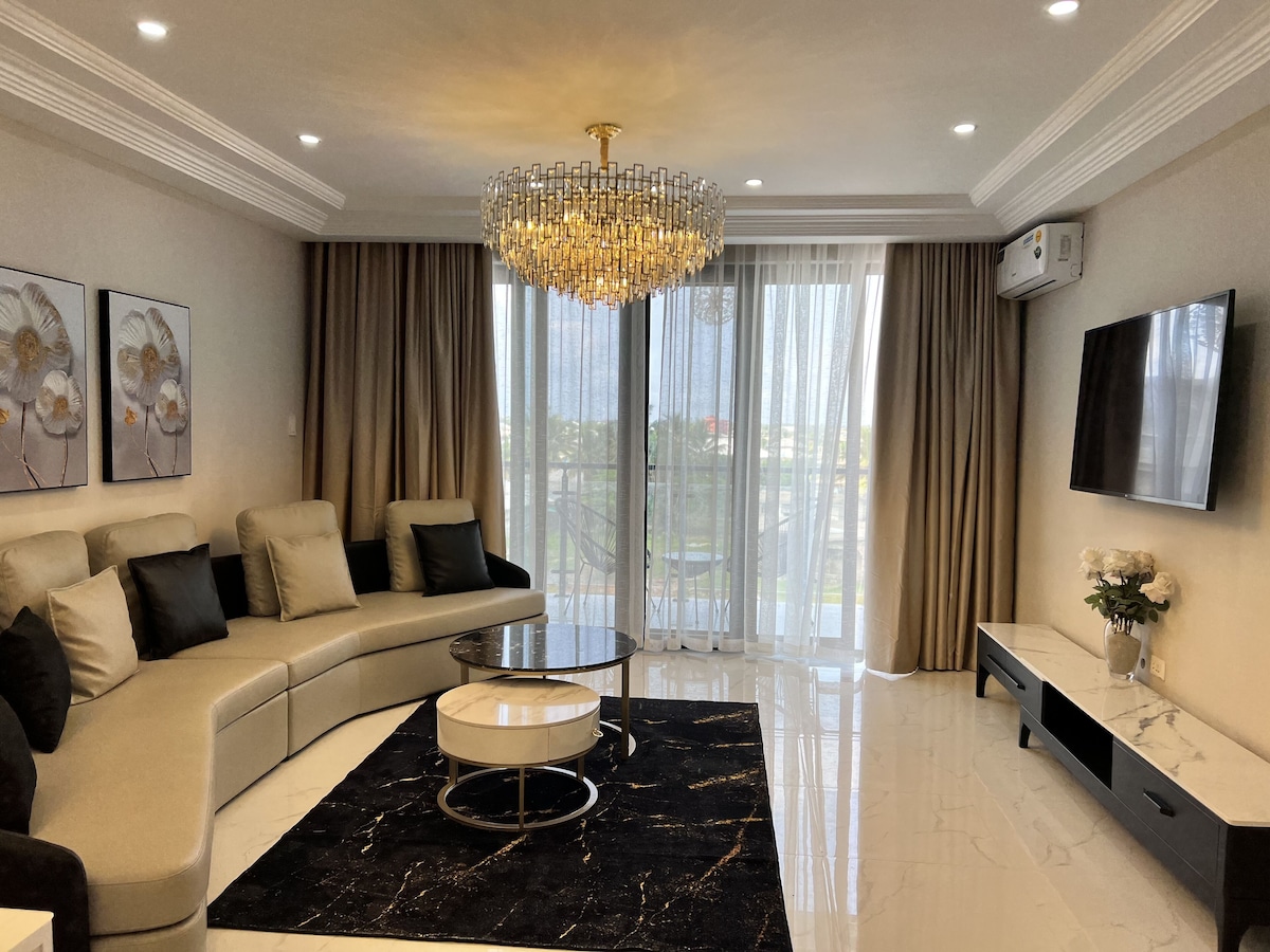 Executive Premium Apartment Suite. | Living area | 55-inch Smart TV with cable channels, TV, printers