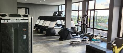 A gym with treadmills, a stationary bike, and a weight machine.
