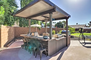 Enjoy dining or socializing in the covered patio with a bar, grill, and barbecue.