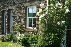 A stone building with a window and a flower box. - Briar Cottage (Cornhill on Tweed)