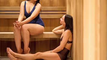 A sauna with wooden benches and a tiled floor.