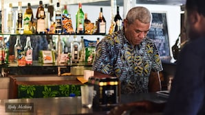A bar with a variety of bottles and snacks on shelves. - Coralview Island Resort (Tavewa Island)