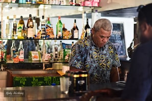 A bar with a variety of bottles and snacks on shelves. - Coralview Island Resort (Tavewa Island)