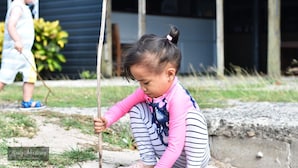 A child playing with a stick outdoors. - Coralview Island Resort (Tavewa Island)