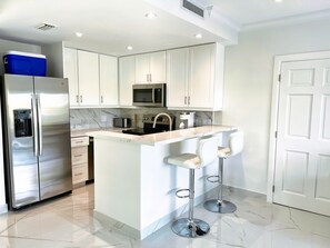 Fridge, microwave, oven, stovetop - 1 Bedroom Luxury Modern Leeward Condo - 5 min walk from the beach (Leeward Settlement)