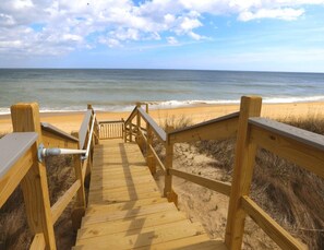 A wooden boardwalk leading to a beach with a clear view of the ocean. - SHORE THING - Spacious 7 BR home w/Private Pool, Hot Tub & Elevator (Southern Shores)