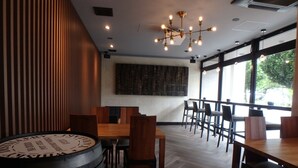 A restaurant interior with wooden flooring, a large wooden barrel, and a modern chandelier. - buransiera naha akebono puremisuto 1009 (Naha)