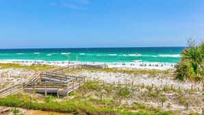 A beach with a wooden boardwalk leading to the shore, sandy beach, and ocean view. - Aegean 309: Spacious 3BR Condo with Gulf Views (Destin)