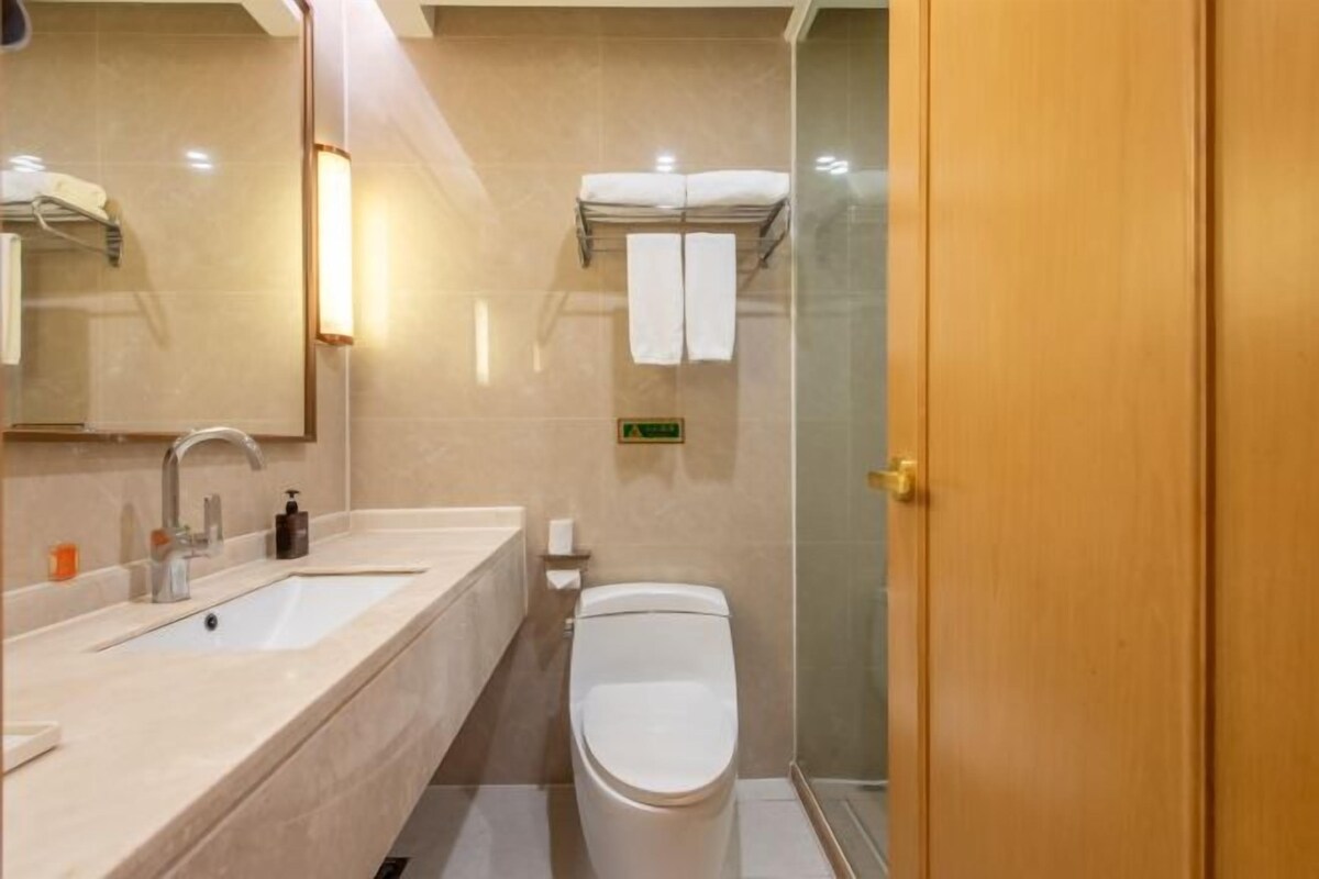 A bathroom with a sink, toilet, and shower.
