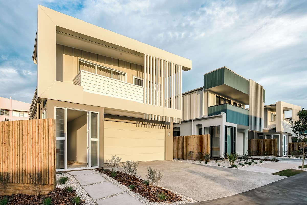 A modern two-story house with a flat roof, large windows, and a minimalist design.