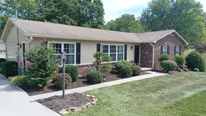 A two-story house with a brick section and a beige siding section. - Discover Maryville and the Great Smoky Mountains (Maryville)