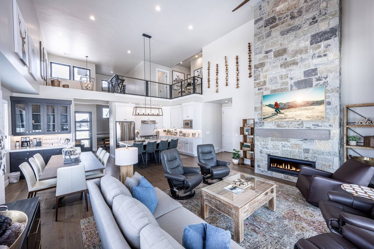 A spacious living area with a fireplace, a dining area, and a kitchen.