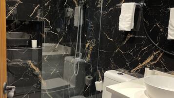 Een douche, een haardroger, een bidet, handdoeken