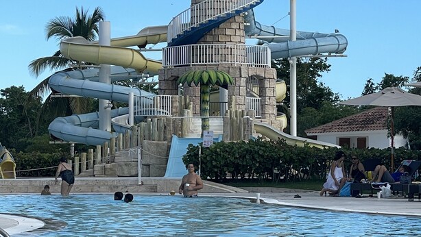 A water park with a central tower, multiple slides, and a swimming pool.