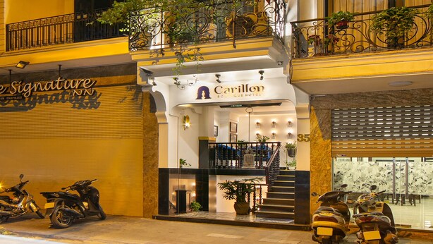 A multi-story hotel with balconies, a sign for 'Carillon', and parked scooters. - Carillon Boutique Hotel (Hanoi)