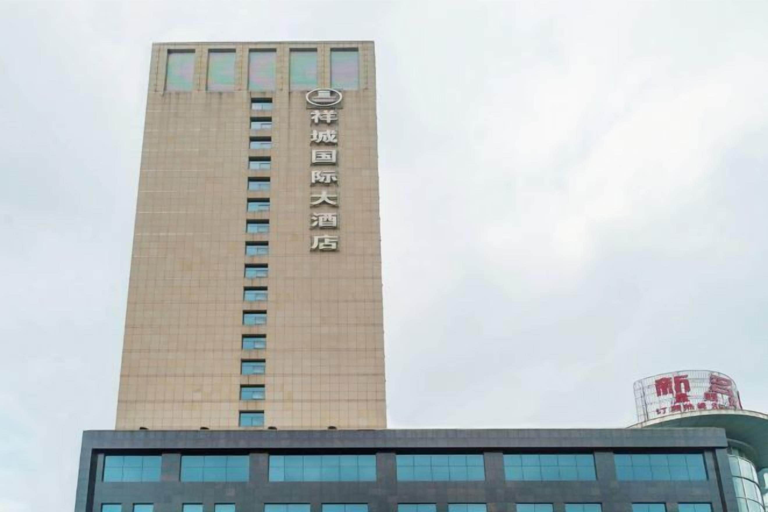 A tall building with a sign indicating it is a hotel.