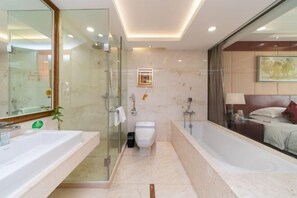 A modern bathroom with a glass-enclosed shower, a large bathtub, and a vanity with a mirror. - Xiangcheng International Hotel (Pingxiang)