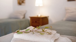 A neatly made bed with a white towel and a branch of greenery on top. - Holiday Apartment "Casita Ana" with Mountain View & Private Terrace (El Paso)