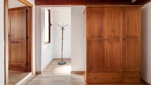 A hallway with wooden doors, a coat rack, and a wardrobe. - Holiday Apartment "Casita Ana" with Mountain View & Private Terrace (El Paso)