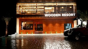 A hotel named "Wooden Resort" with a modern design, featuring a large glass entrance and a brick-paved driveway. - Wooden ECR Sea Resort (Marakkanam)
