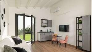 A modern kitchen with a dining area, a TV, and a large window. - Nice villa with pool near Noto, Sicily (Noto)