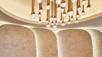 A reception area with a modern design, featuring a curved wall and two seating areas.