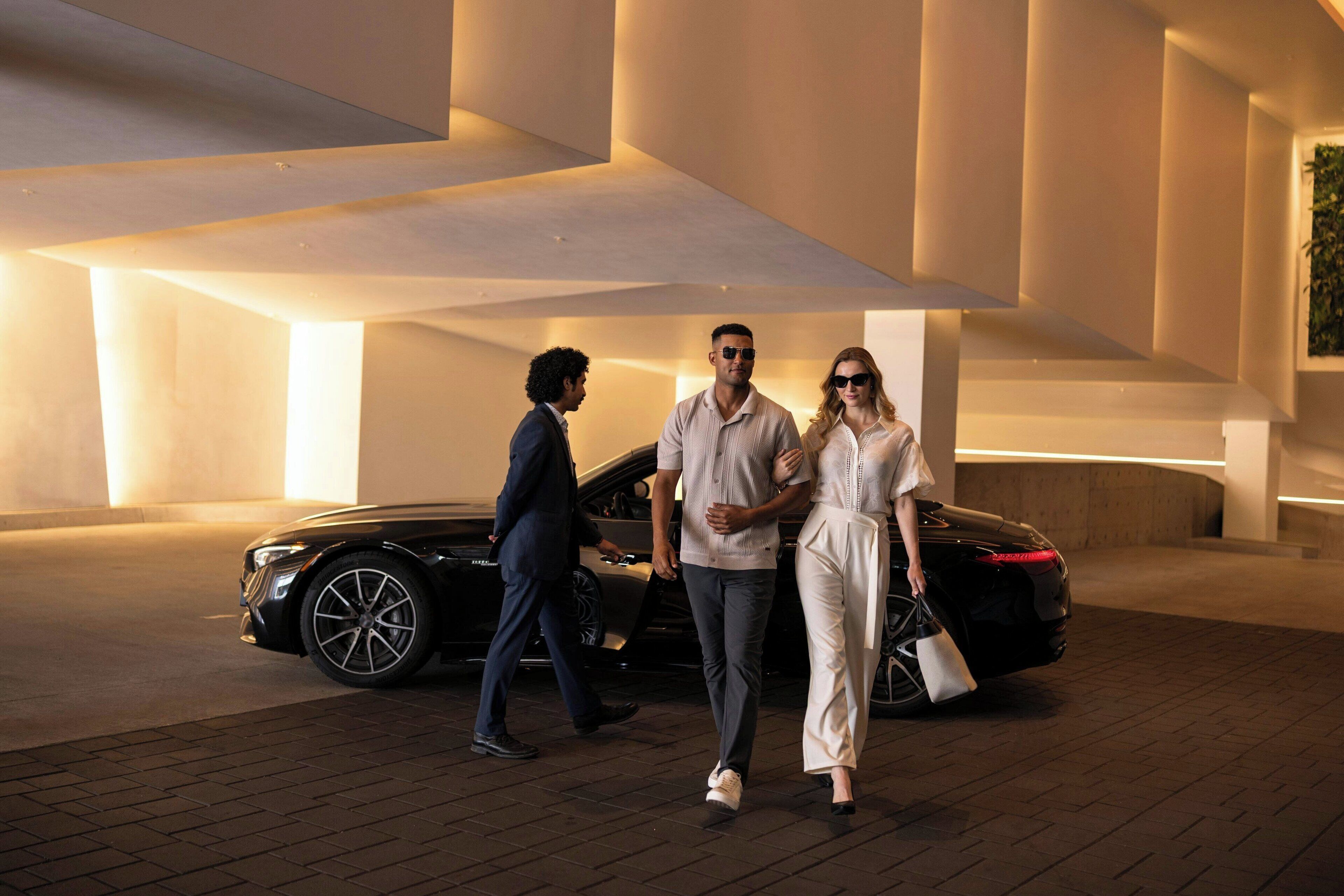 A modern building with a spacious interior and a parked car.