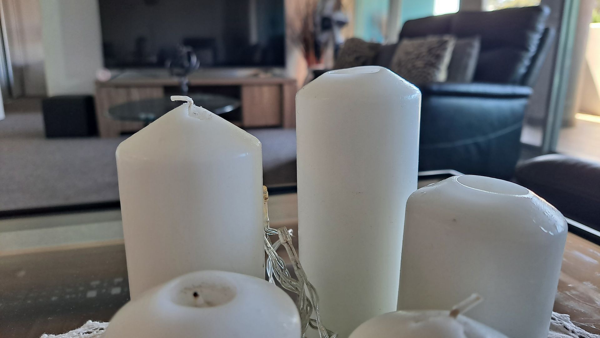 A table with four white candles.