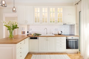 Enjoy cooking in this well-equipped kitchen with a dishwasher, stove, and sink.