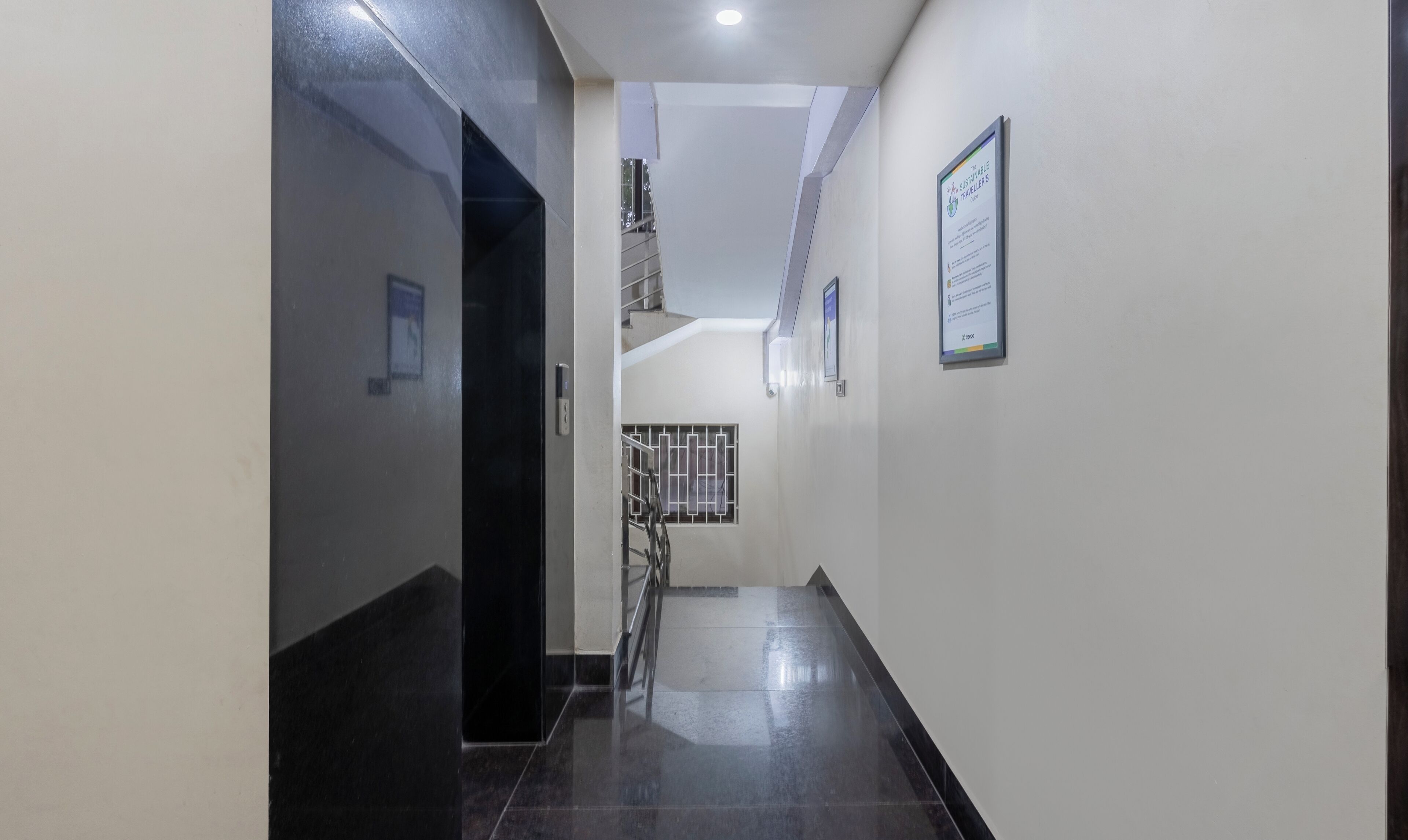 A corridor with a staircase leading to a landing.