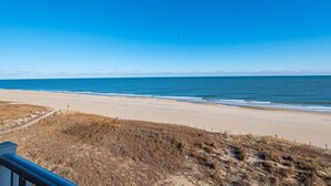 A beach with a clear sky and a distant mountain range. - Newly renovated 2 bedroom, 2 bath condo with beautiful views of the ocean! (Ocean City)