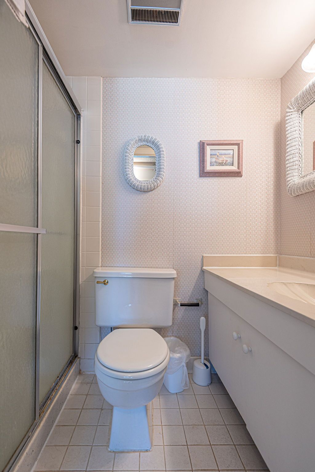 A bathroom with a toilet, bidet, and a shower area.