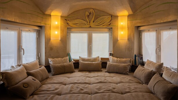 A large, centrally positioned bed with multiple pillows, flanked by windows with curtains, and wall-mounted lighting fixtures. - Cerrado das Fontainhas (Sintra)