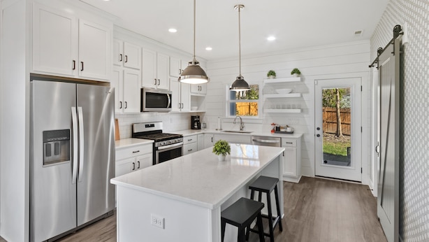 A modern kitchen with white cabinetry, stainless steel appliances, and pendant lighting. - DerbyGrove: Newly Renovated & Near Derby (Jeffersonville)
