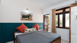 A bedroom with a bed, a ceiling fan, a window with curtains, and a wall-mounted picture of an elephant. - Villa Calangute Phase 7 (Candolim)
