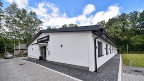 A modern building with a sign reading "SPORT ROOMS" indicating a sports facility. - Sport Rooms Spała (Inowlodz)