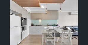 Enjoy meals in this kitchen with an oven and dining area.