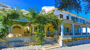 A two-story building with a balcony, stone steps, and a sign that reads "Fresh Fish". - Theophilos 1 in (Corfu)