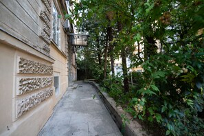 Stroll through this charming alleyway lined with historic buildings and lush greenery.