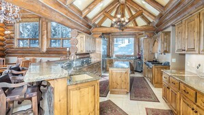 A spacious kitchen with wooden cabinets, granite countertops, and a large island. - BEARPAW MANOR- A Magnificent Ski-In/Ski-Out Mountain Village Chalet (Mountain Village)