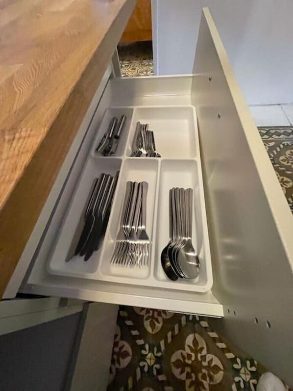 A drawer with utensils neatly organized in compartments. - Chic and classic apartment in Santurce - Apt #5 (San Juan)