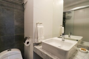 A modern bathroom with a white sink, a toilet, and a shower area. - w* | 1BR near Central Restaurant in Barranco (Barranco)